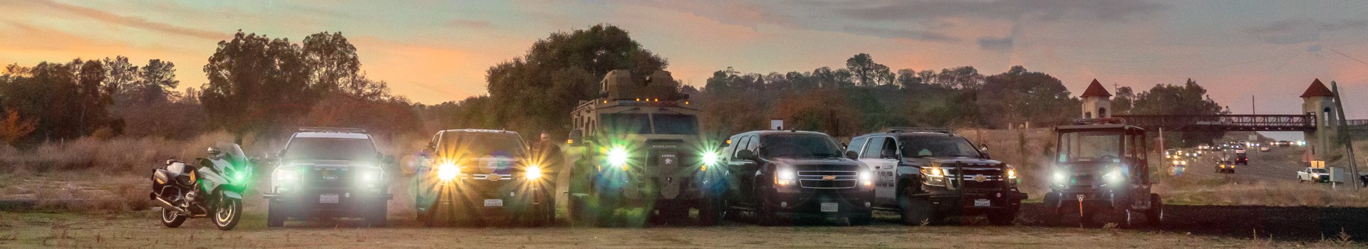 Folsom Police Vehicles with Headlights On next to Johnny Cash Bridge