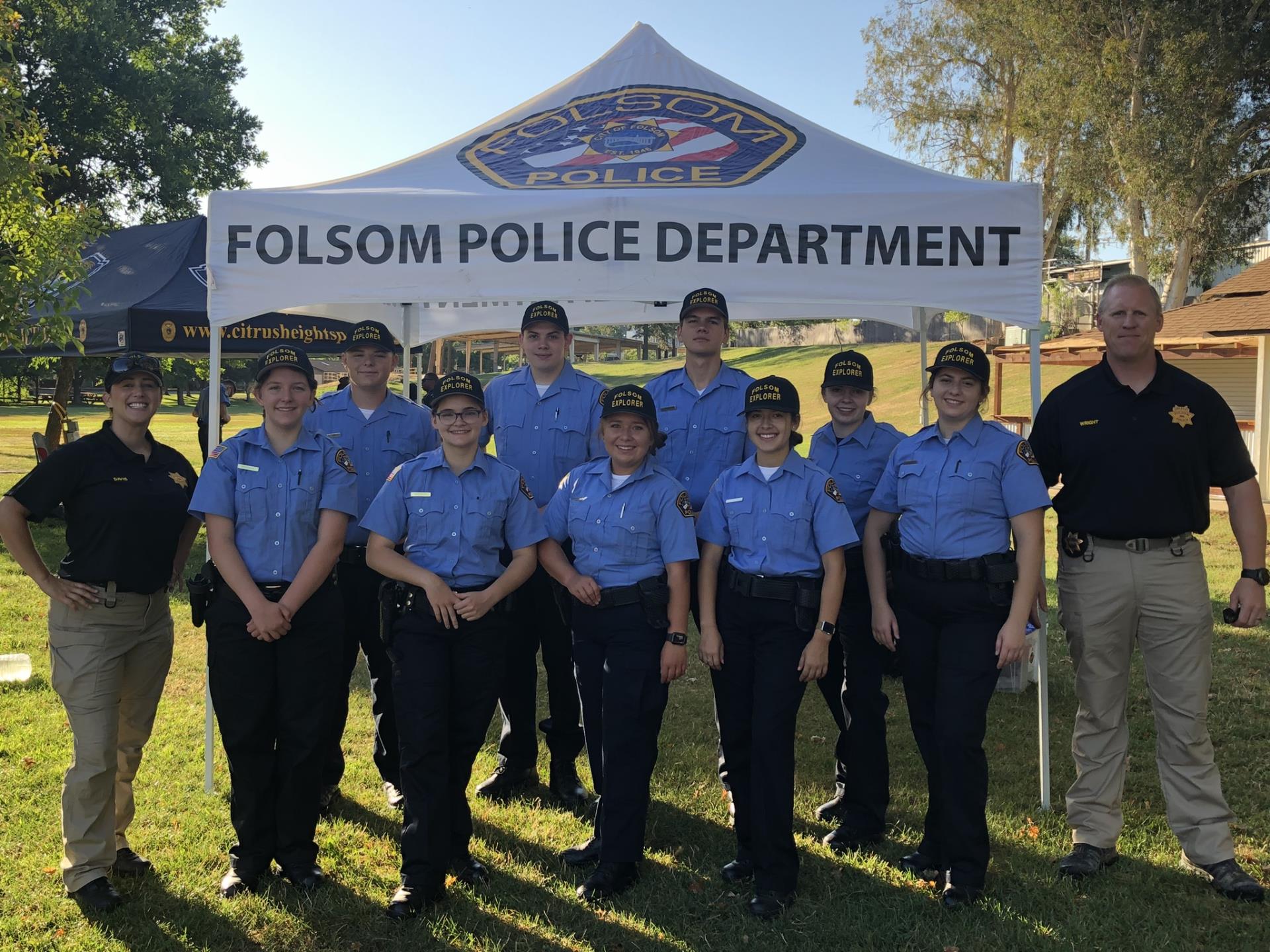 Youth Police Explorers with Leaders in front of Folsom Police Department tent