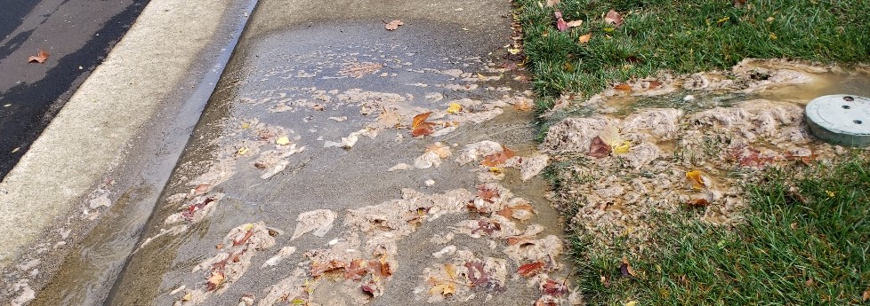 Sewer spilling onto road