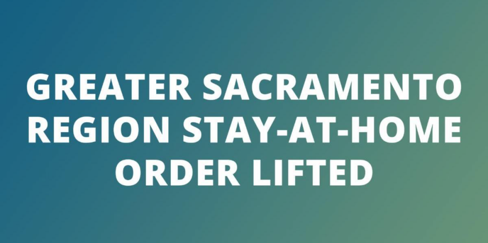 greater sacramento county stay-at-home order lifted announcement in white text on a blue to green gradient background