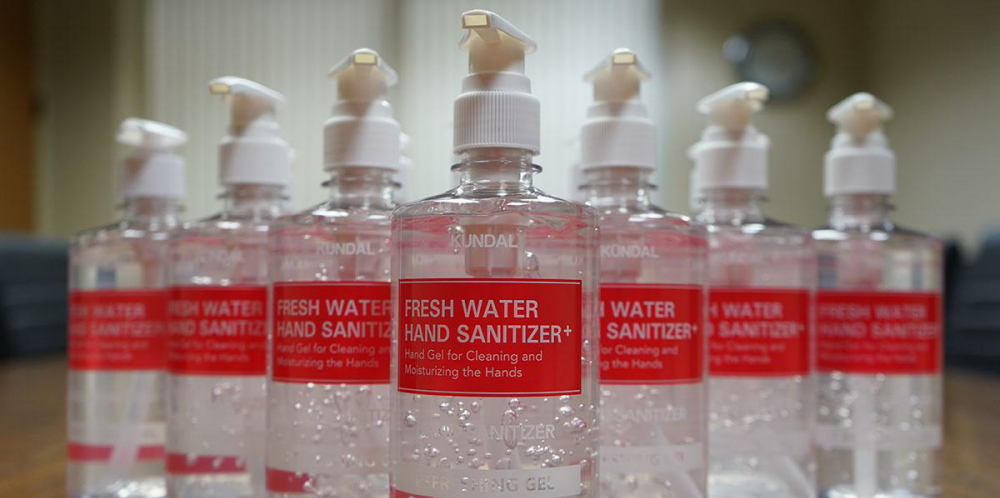 Photo of Fresh water Hand Sanitizer on a red label lined up next to each other
