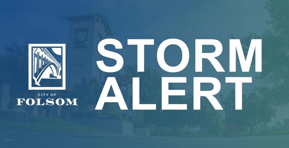 city of folsom storm alert graphic in white text with a dark blue overlay and a picture of City hall in the background and a white city of folsom logo to the left of the text