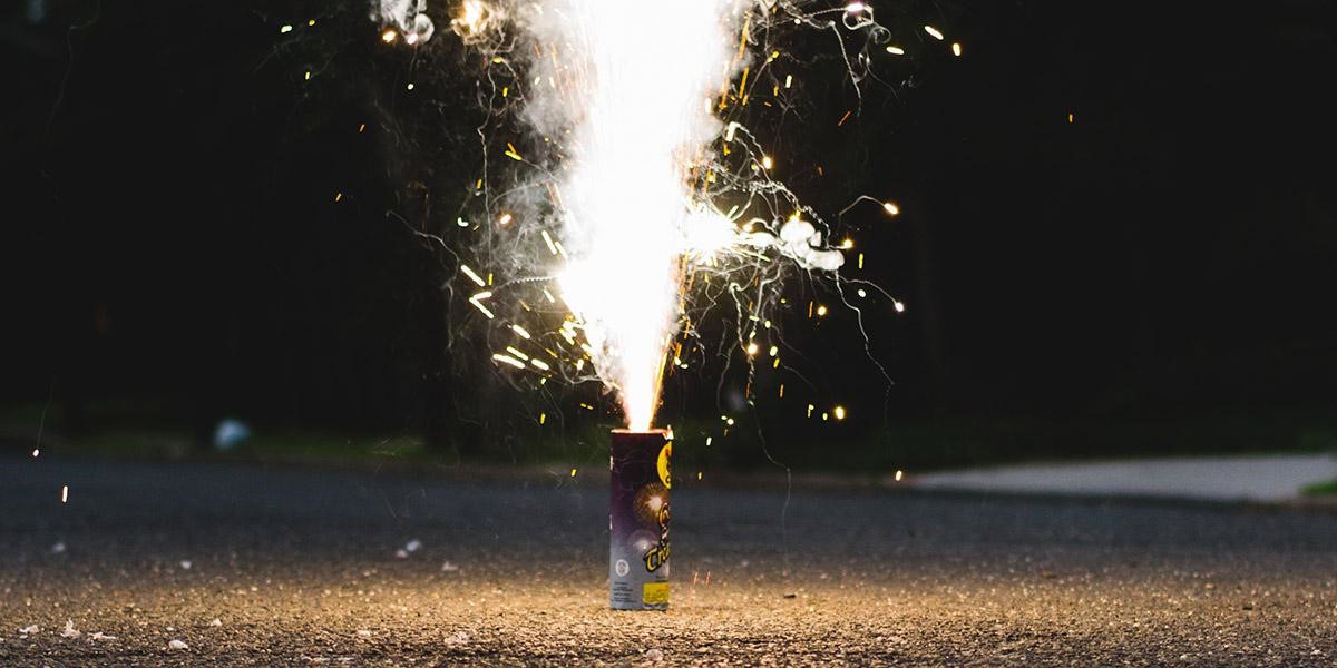 diwali photo of a lit firework on the ground