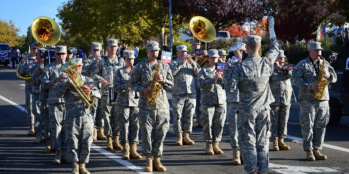 veterans parade of military playing band instruments on the street