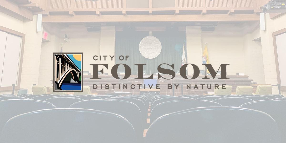 council chambers in the background with a white transparent overlay and the side by side city of folsom colored logo in the center of the image