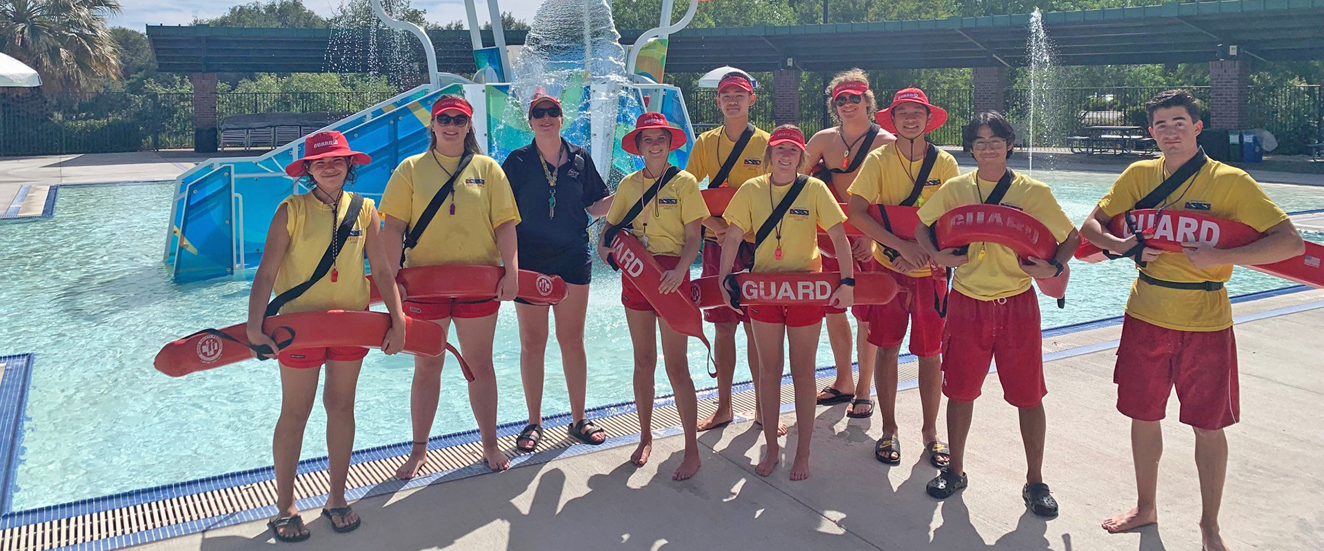 aquatic center lifeguards in front of the play water structure 