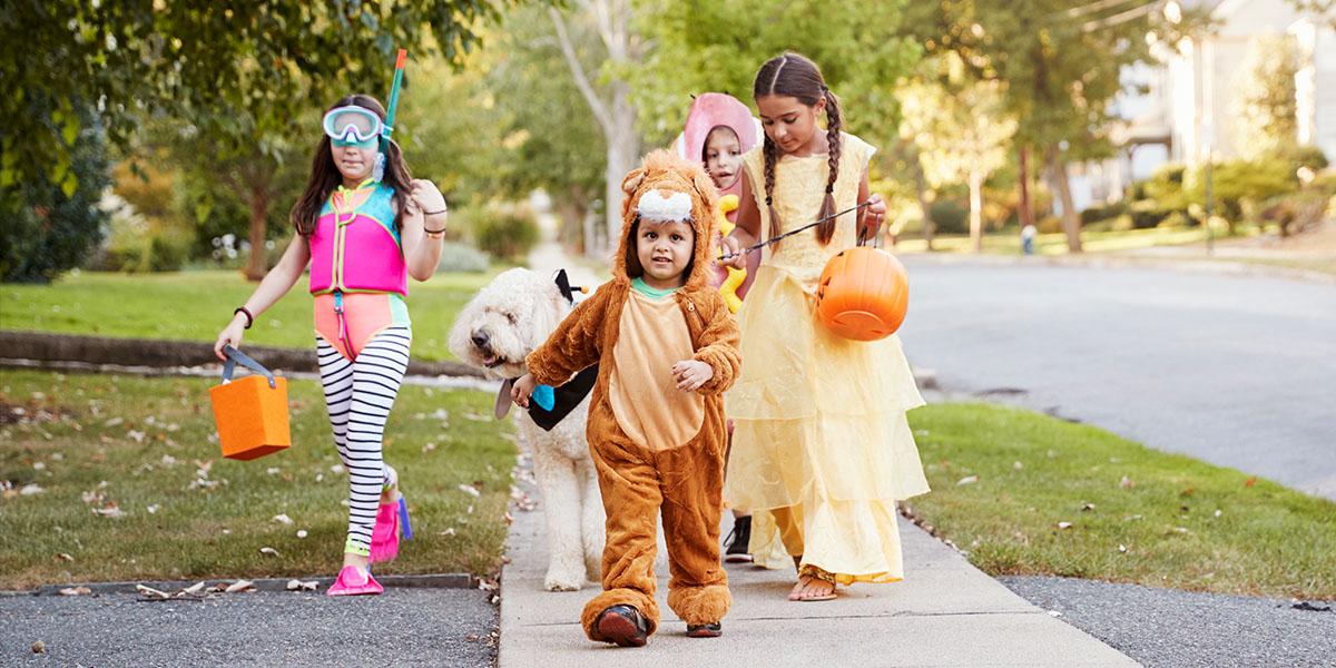 trick-or-treaters outside on the sidewalk
