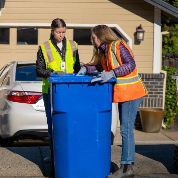 folsom staff checking blue waste bin for contaminates