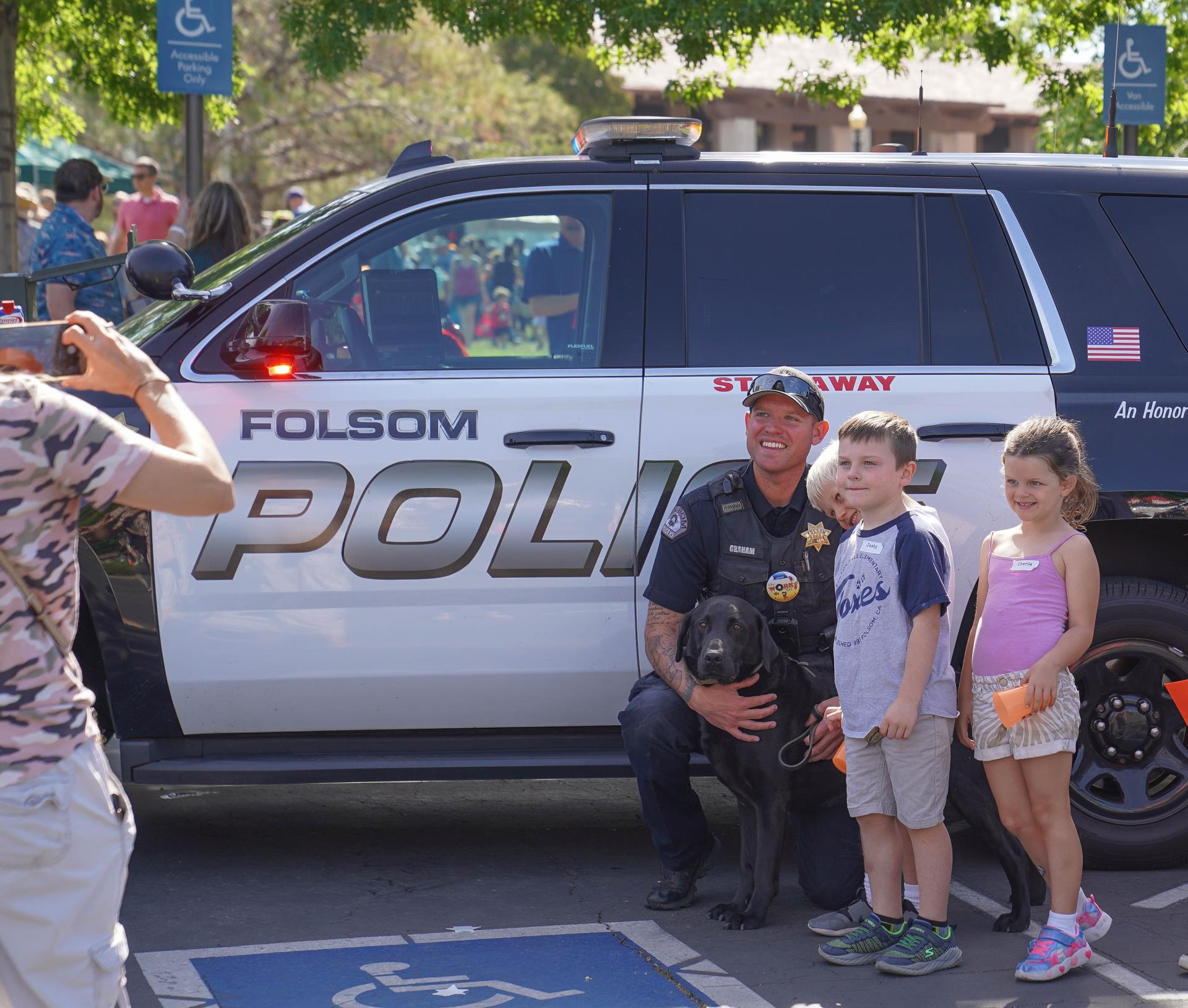 Police office posing for photo with kids