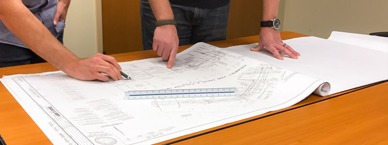 Engineers reviewing engineering plans