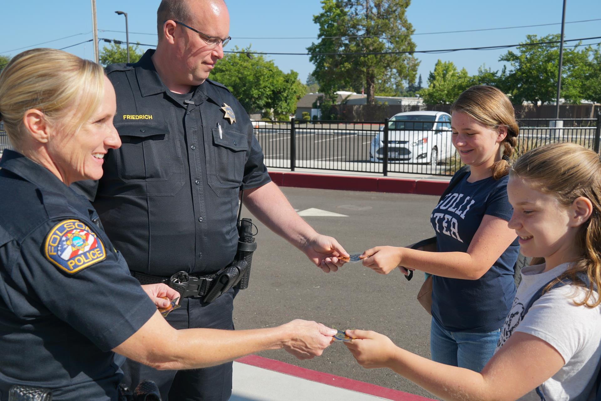 Officers handing stickers to kids